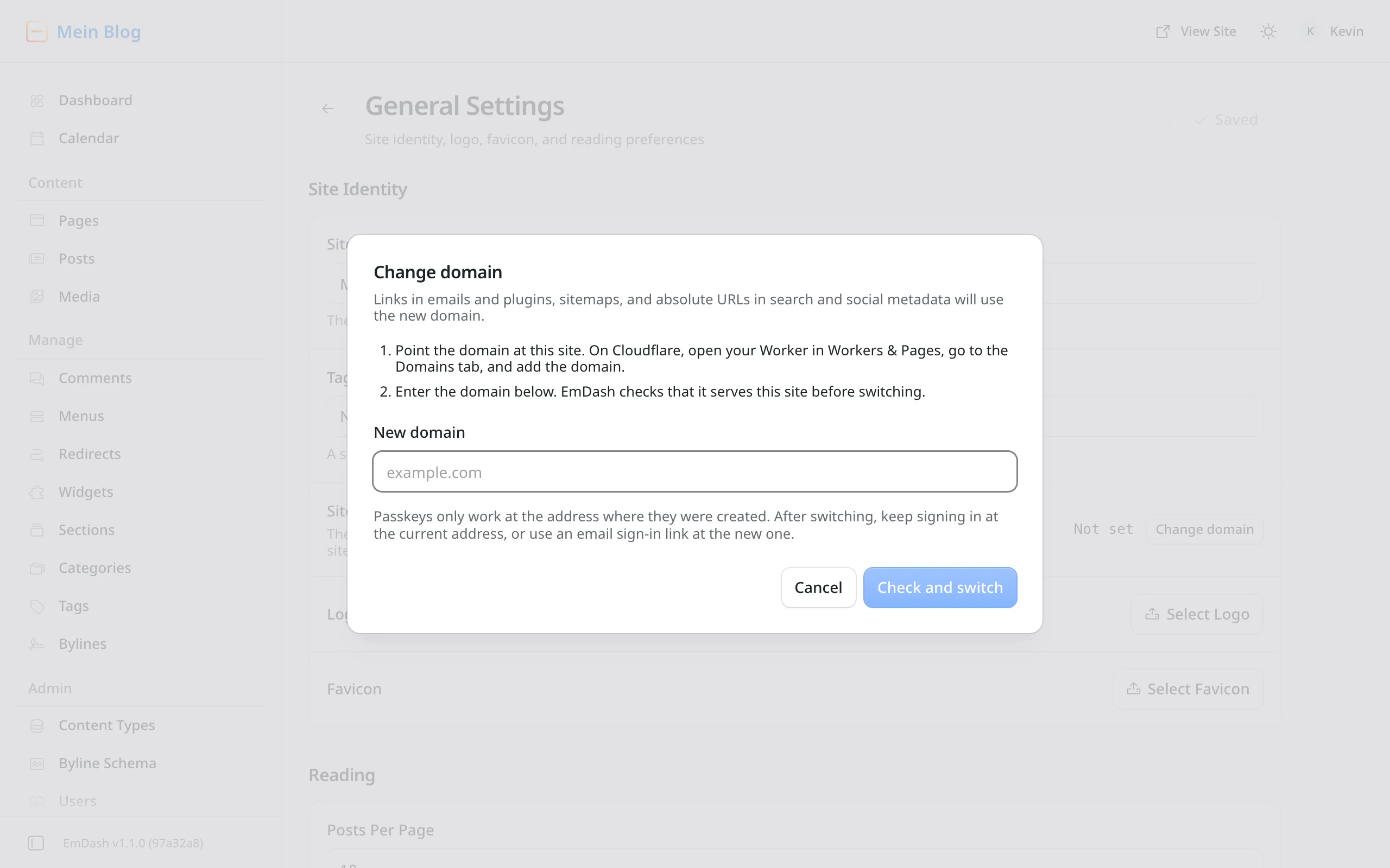The "Change domain" dialog in EmDash's general settings. Two steps: point the domain at the Worker on Cloudflare and enter the new domain. Below, a "New domain" field, a note about passkeys and the buttons Cancel and Check and switch.