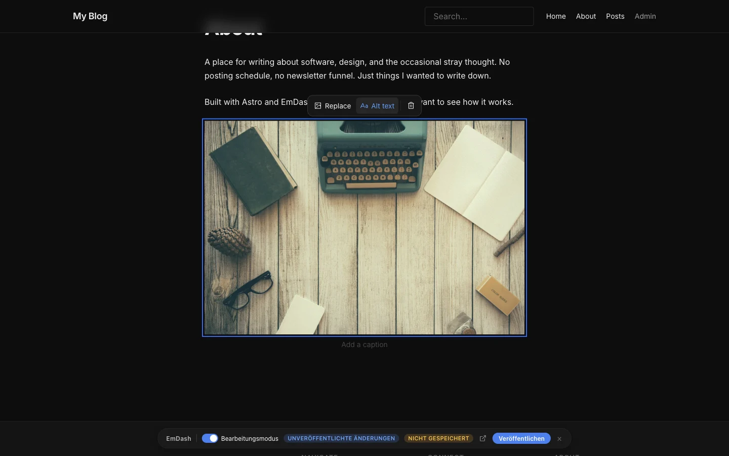 The About page of the blog template in edit mode. An inserted photo of a typewriter has a blue outline, above it a toolbar with Replace, Alt text and a bin, below it "Add a caption". At the bottom the EmDash bar with unpublished changes and the button Publish.